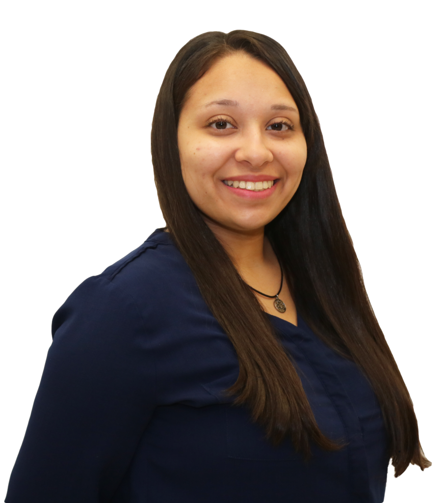 The image shows a woman smiling against a white background. She has long, straight dark hair and is wearing a navy blue blouse. Her expression is warm and friendly, and she is facing slightly to the side, giving a three-quarter profile. She is also wearing a black necklace with a round pendant. The overall tone of the image is professional, and business portrait.